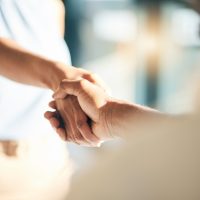 Handshake, hello and hands of people meeting for partnership or agreement together as a team with trust. Greeting, accept and thank you or welcome gesture for deal, collaboration and support.